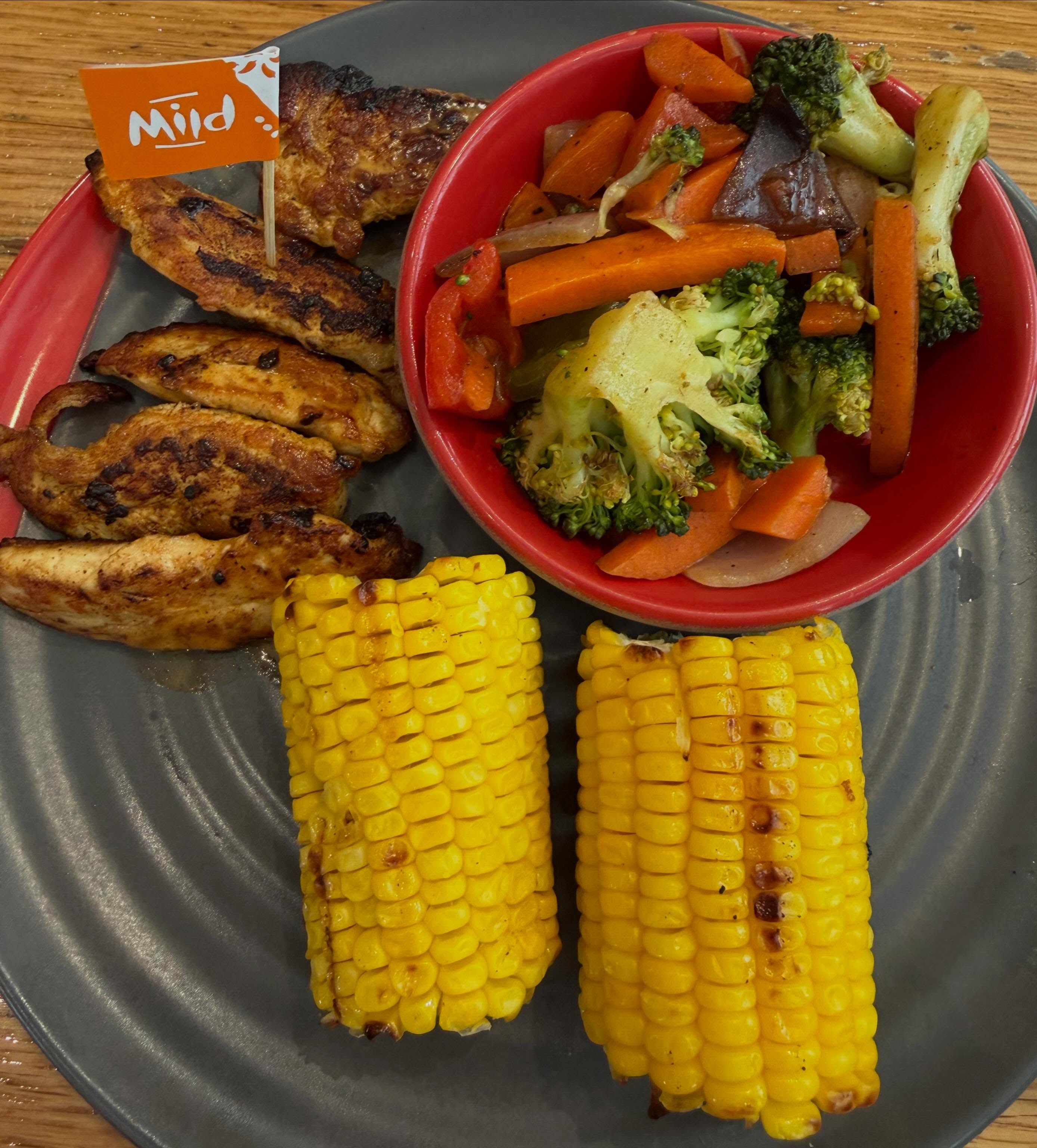 Nando's grilled chicken tenders + corn + mixed veg!