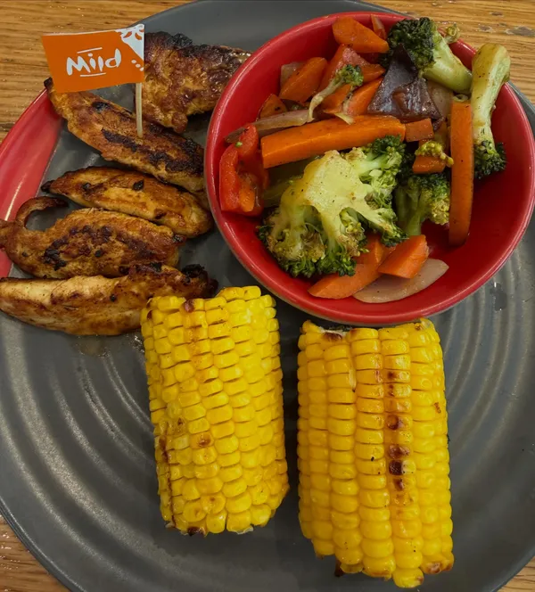 Nando's grilled chicken tenders + corn + mixed veg!