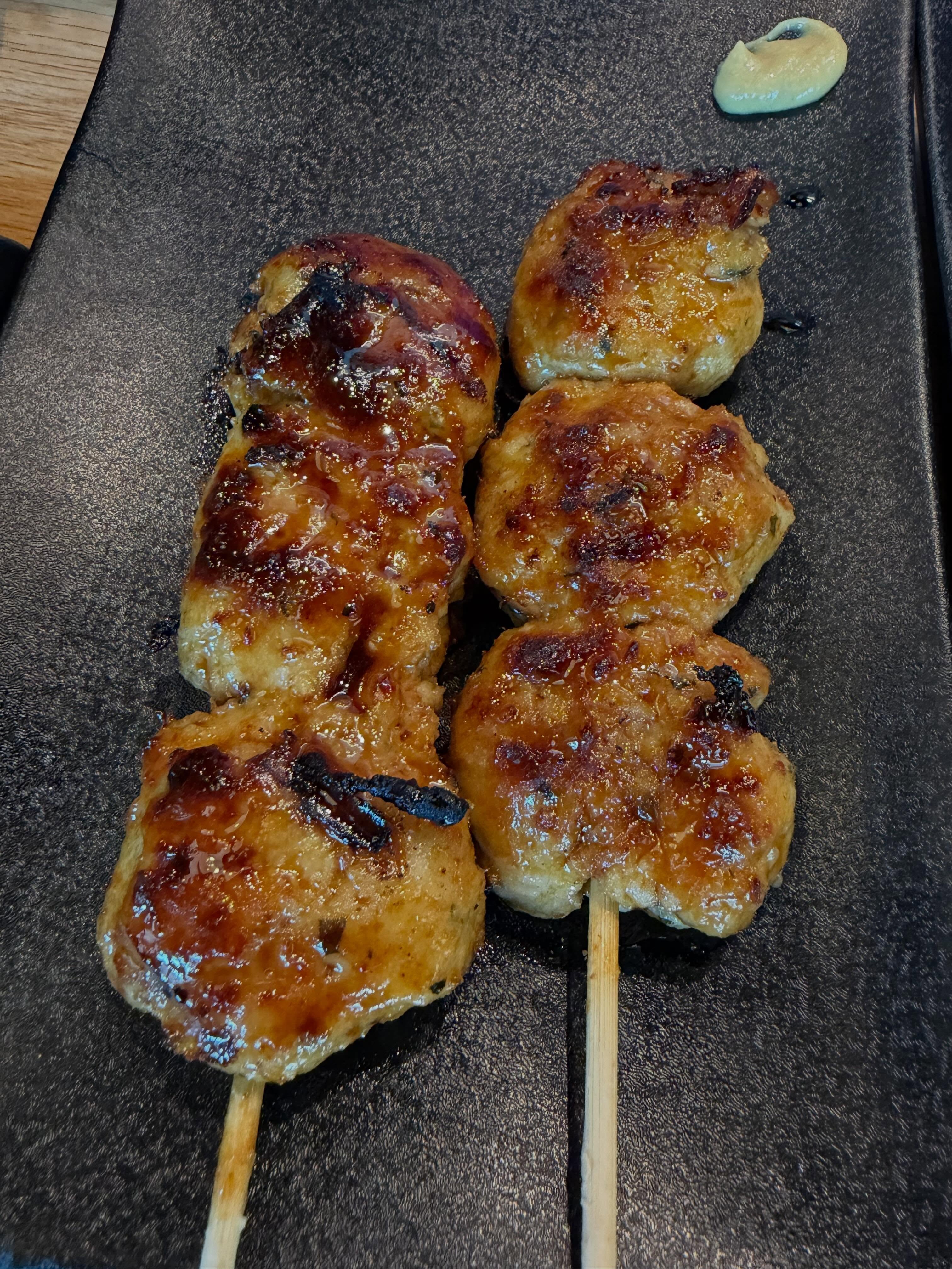 Tsukune chicken meatball skewers glazed with tare at Torikizoku