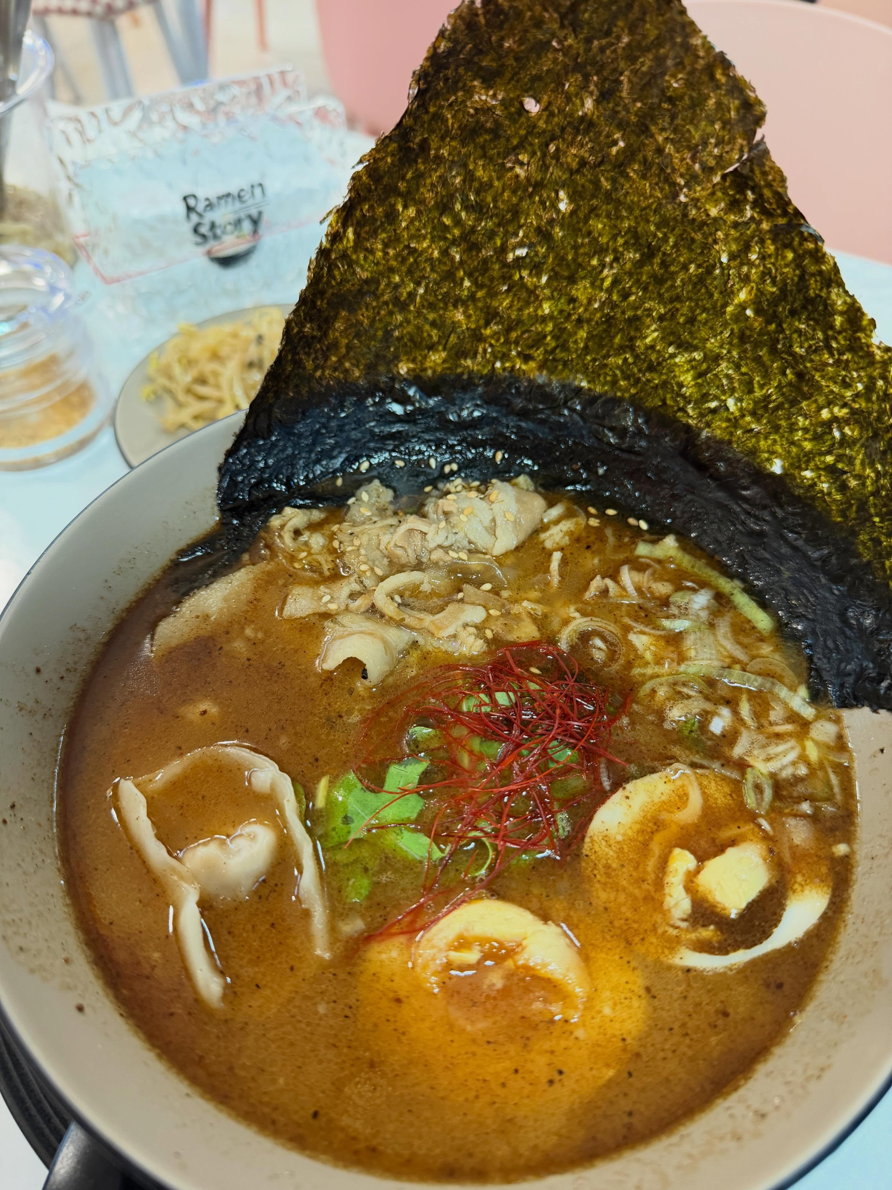Black Gold King ramen with seaweed canopy, ajitama and dumplings at Ramen Story